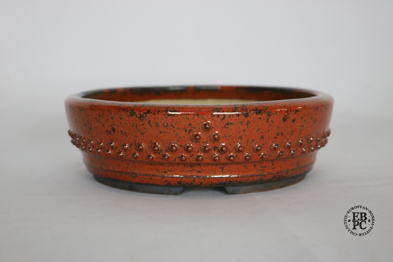 Ian Baillie - 18.2cm; Kifu; Red Crystalline Glaze; Gunmetal/Grey; Round; Studded Drum Design; Incised Basal Band; Recessed Feet; Hand-signed and &#39;IB&#39;, &#39;Scotland&#39; &amp; &#39;EBPC&#39; Stamped.