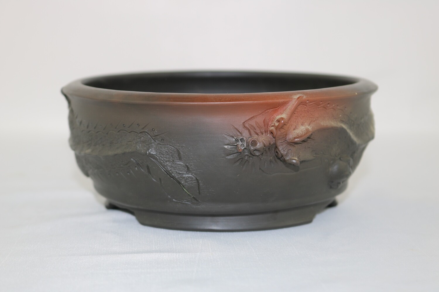 Motozo, Japan.  16.2cm; Round; Unglazed; Dragon in Relief; Detailed Work; Stamped By the Artist;