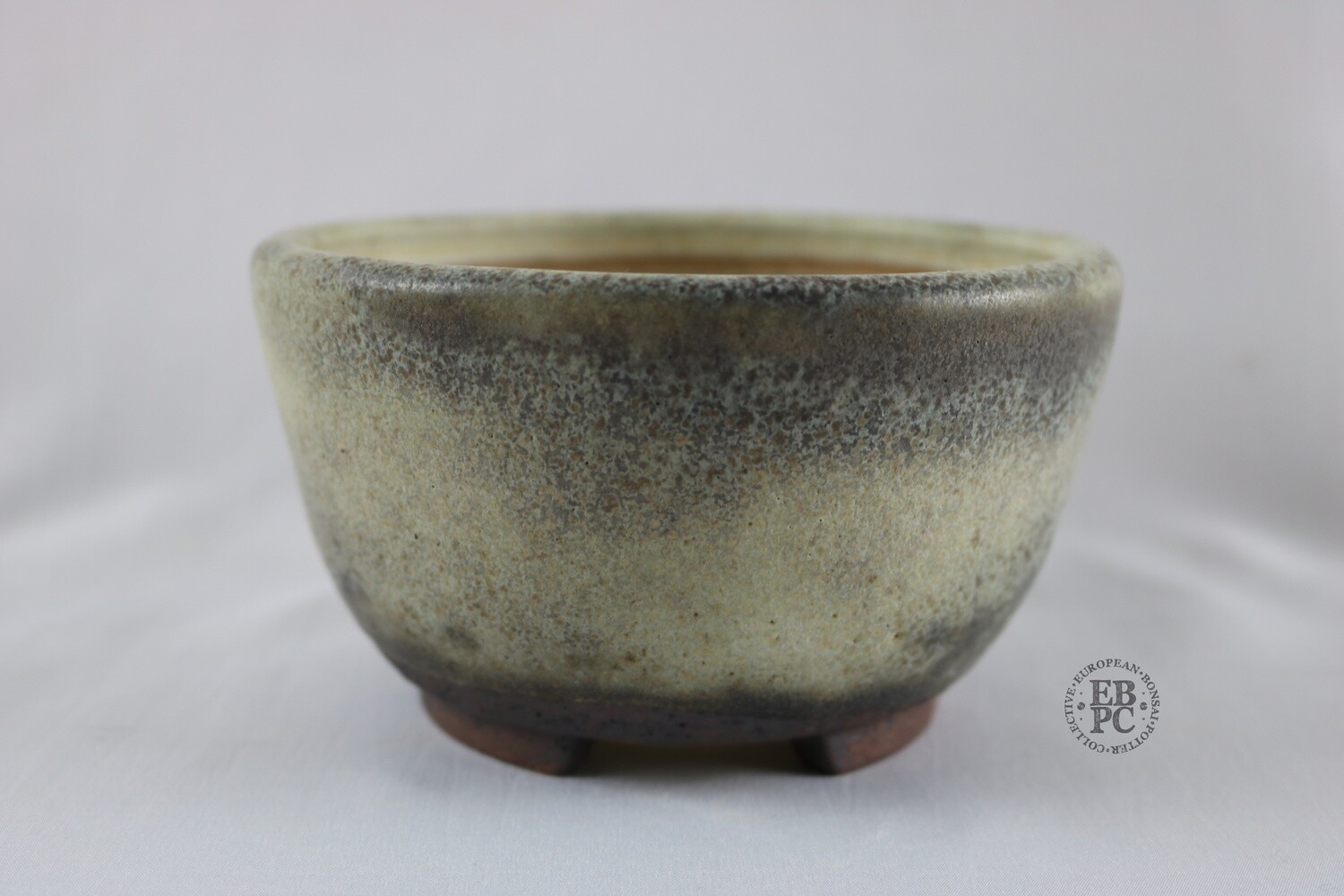 Ian Baillie - 13.7cm; Glazed; Round; Cream; Brown; Hints of Green; Aged looking Glaze; Hand-signed; EBPC Stamped