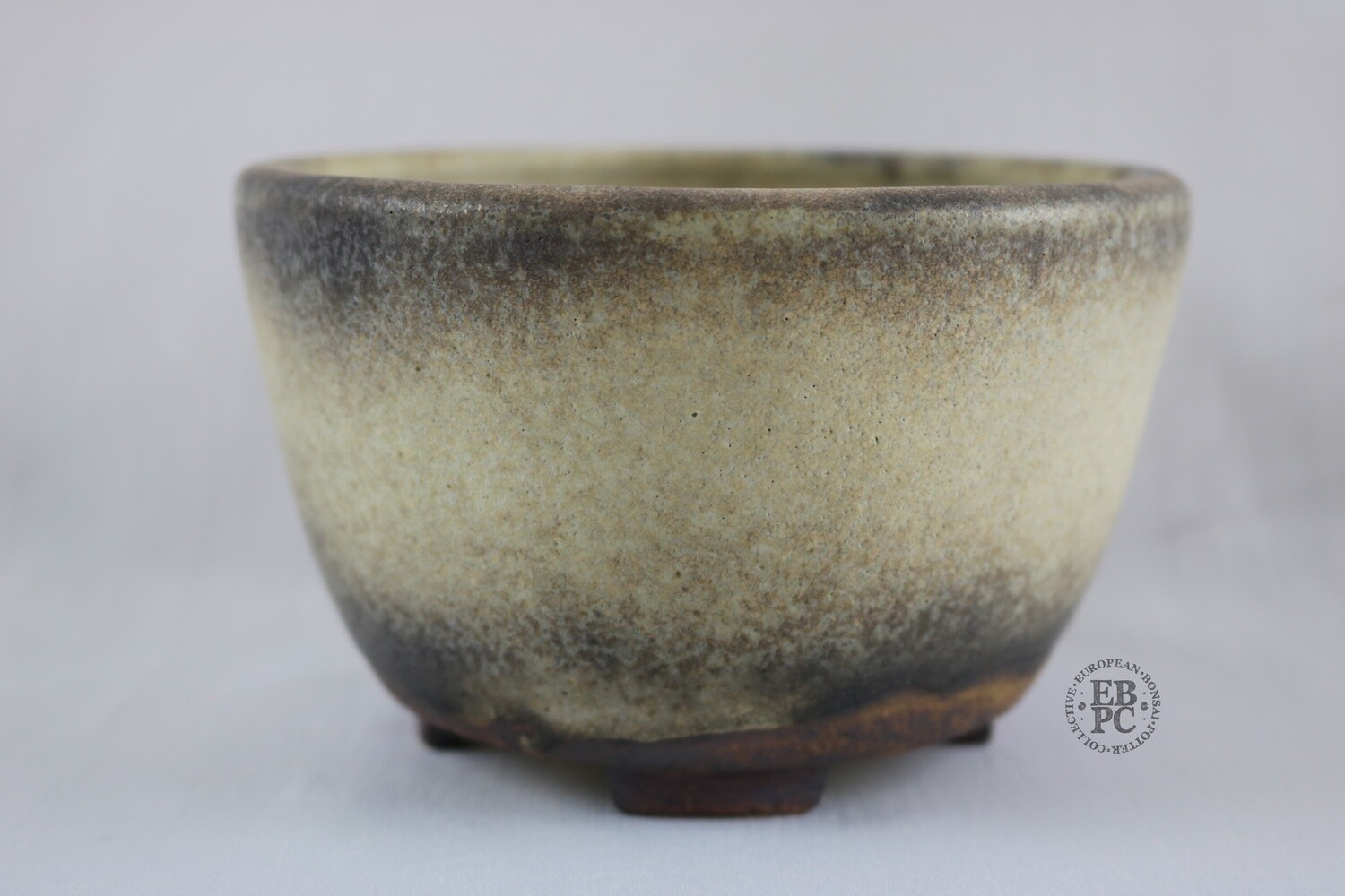 Ian Baillie - 13.6cm; Glazed; Round; Cream; Brown; Aged looking glaze; Hand-signed; EBPC Stamped