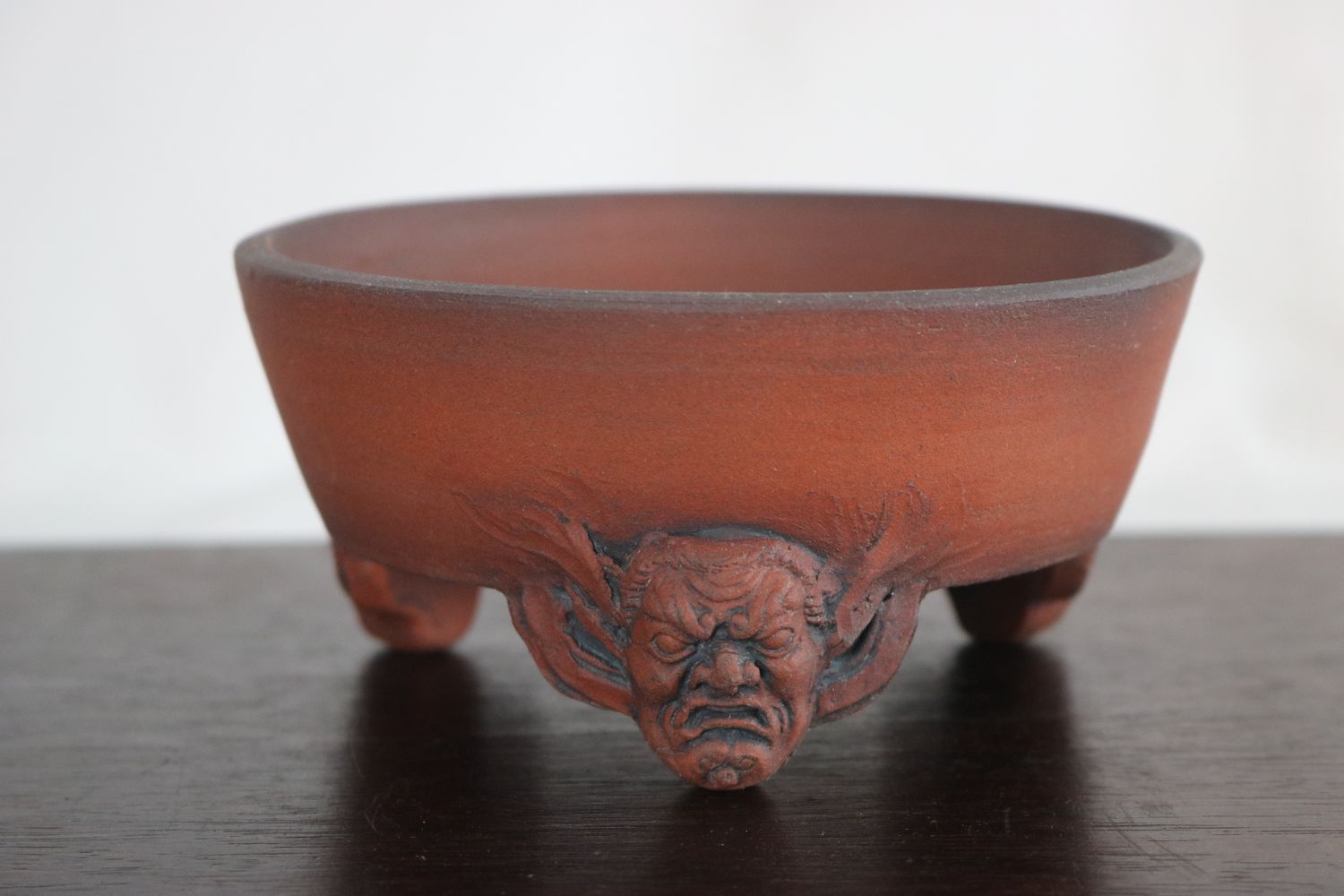 Greg Ceramics - 13.6cm; Round; Unglazed; Sculpted Feet; Ogre Heads: Refined Finish. EBPC Stamped.
