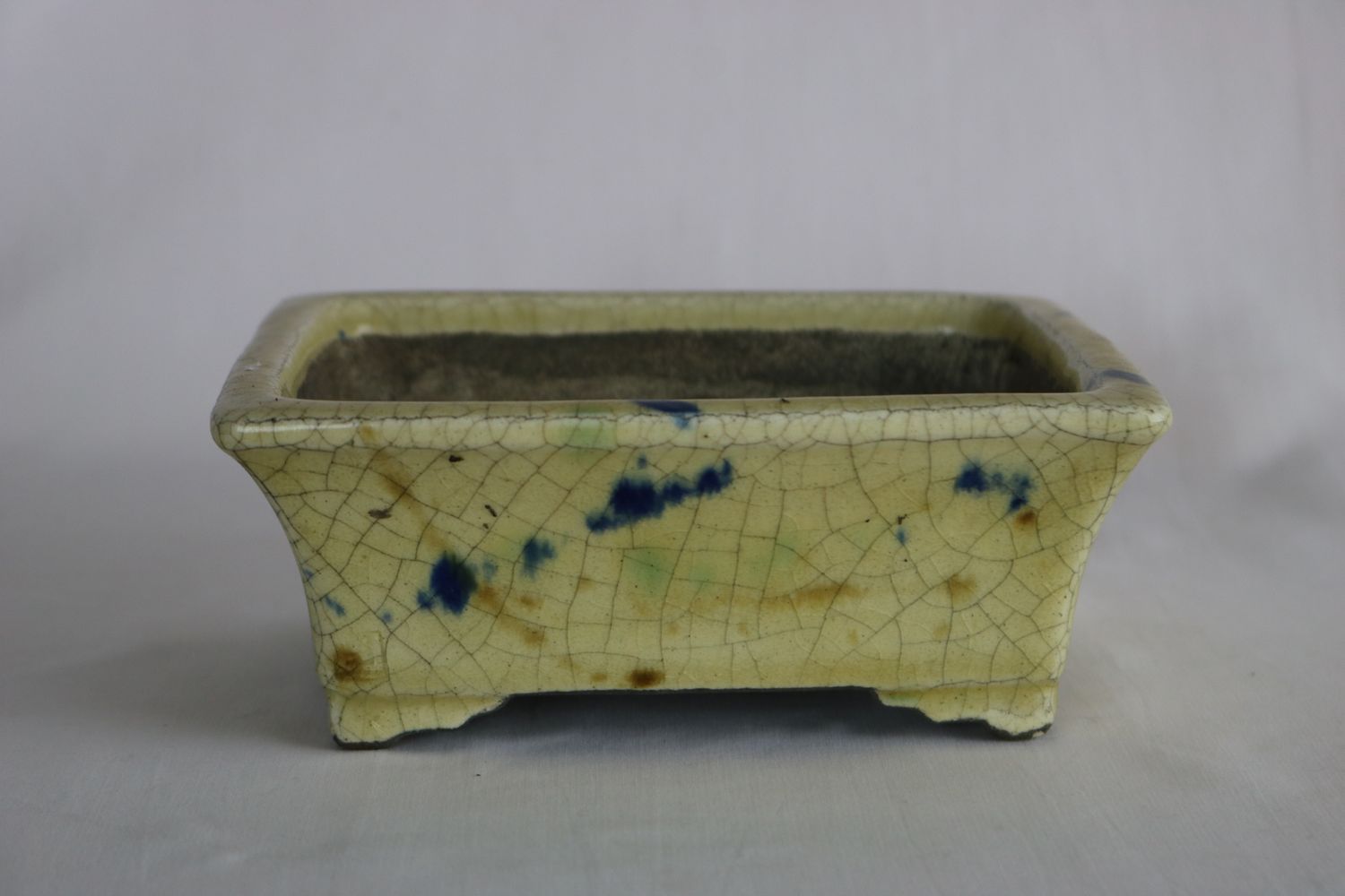 Satomi Terahata, Japan.  16cm; Rectangle; Glazed; Cream Crackle Glaze; Splashes of Green &amp; Blue; Stamped by the artist;