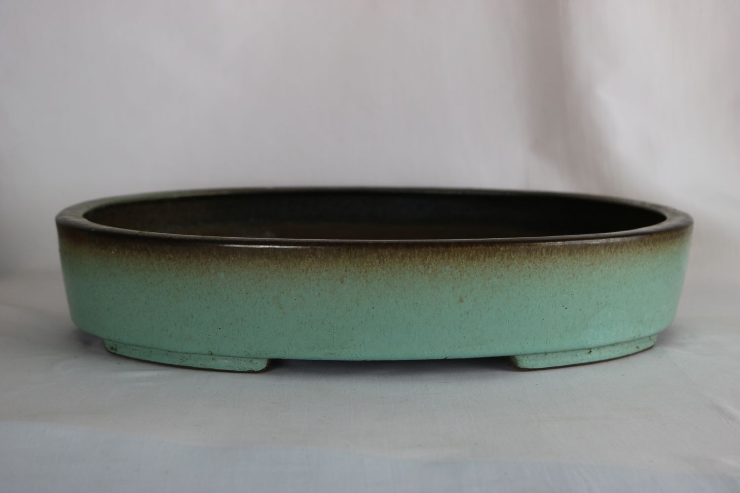 Yixing, China.  40cm Oval; Green; Brown Rim; Pre-loved;