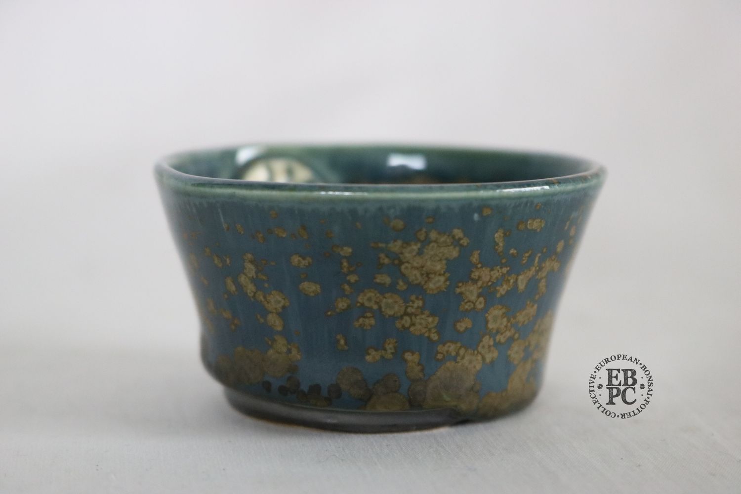 Sabine Besnard - 6.2cm; Round; Oak Ash Glaze; &#39;Yuuki d&#39;Or Bleu&#39; Glaze&#39;; &#39;Blue Gold&#39;; Browns; Crystalline Glaze; EBPC Stamped;