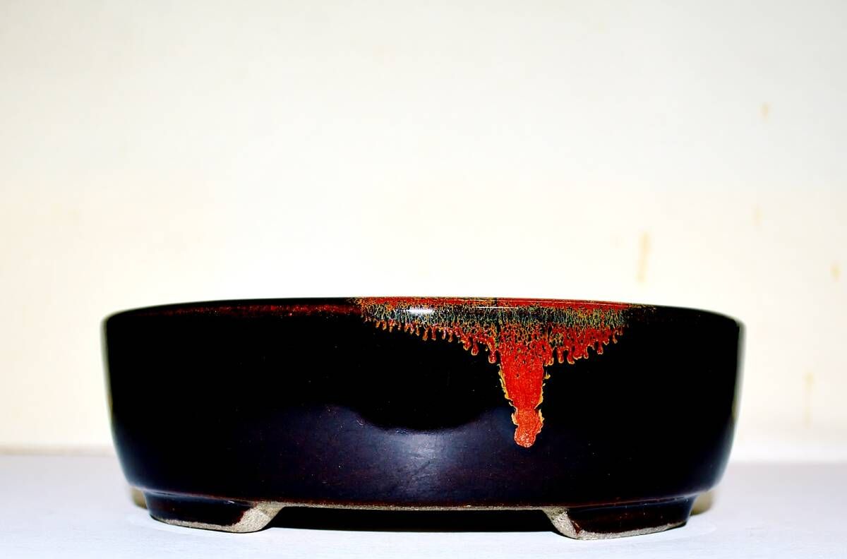 SATOMI Terahata - Tokoname.   15.8cm; Oval; Glazed; Almot Black; Tenmoku glaze; Brilliant Red Flash;  * Offered on behalf of a client. .