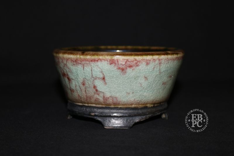 Eddie Curtis, England   - 12.8cm; Hand-thrown; Round;  Exceptional Celadon Glaze; Blood-Red Veins; Crackle Effect; Basal Band; Oxide Finished Carved Feet; Stamped with EBPC &amp; Artist&#39;s Logo.