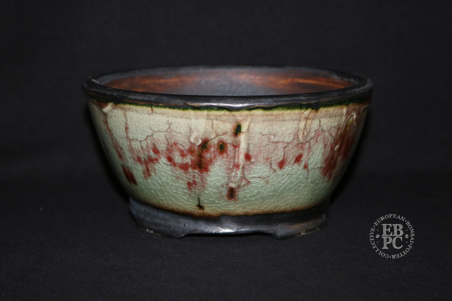 Eddie Curtis, England.   - 18.2cm; Hand-thrown; Round;  Exceptional Celadon Glaze; Blood-red Veins; Crackle Effect; Oxide Finished Foot Ring &amp; Feet; Stamped with EBPC &amp; Artist&#39;s Logo.