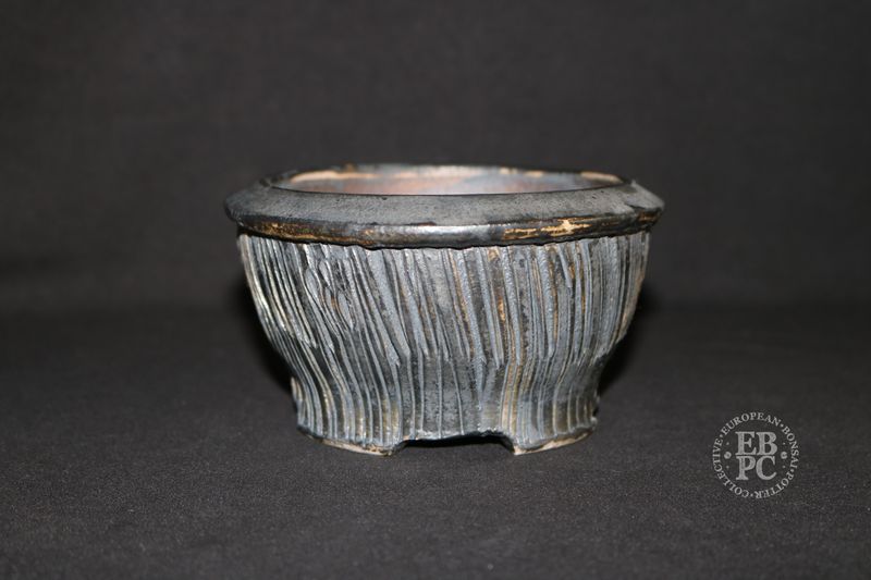Eddie Curtis, England.   - 13.3cm; Hand-thrown; Round; Ribbon-like Texture; Gunmetal Grey; Browns; Glaze &amp; Oxide Finished; Foot Ring &amp; Feet; Stamped by the Artist.