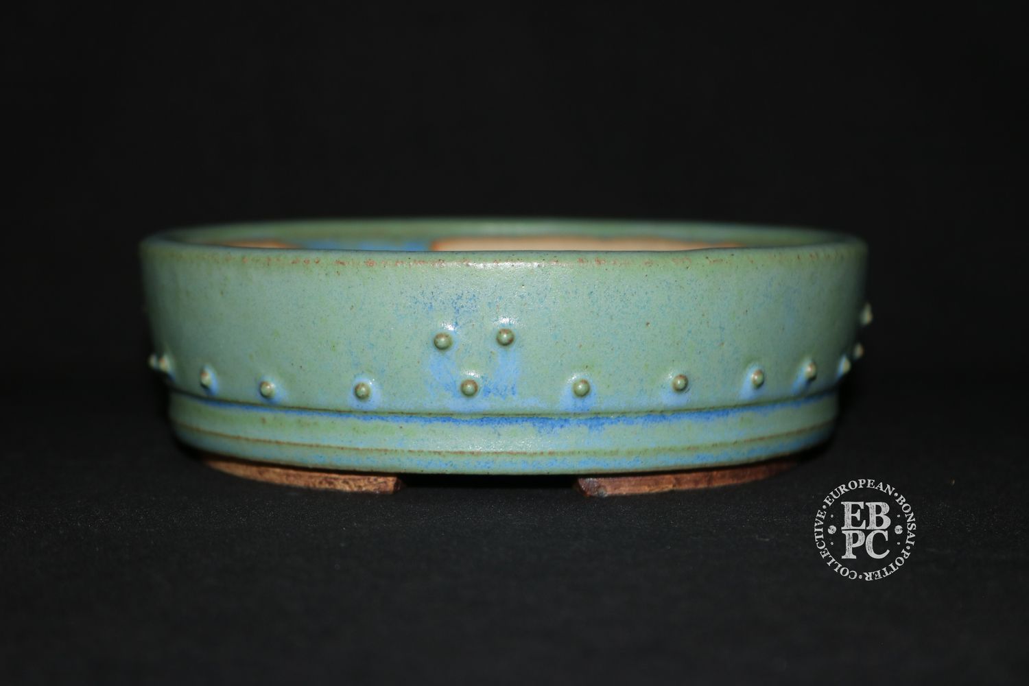 Ian Baillie - 16.1cm; Round; Drum Style; Superb Glaze; Rivets/Studs; Pastel Greens; Light Blues.      Made by Ian Baillie of Scotland.