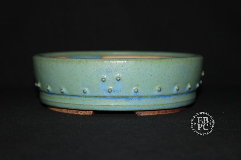 Ian Baillie - 16.1cm; Round; Drum Style; Superb Glaze; Rivets/Studs; Pastel Greens; Light Blues.      Made by Ian Baillie of Scotland.