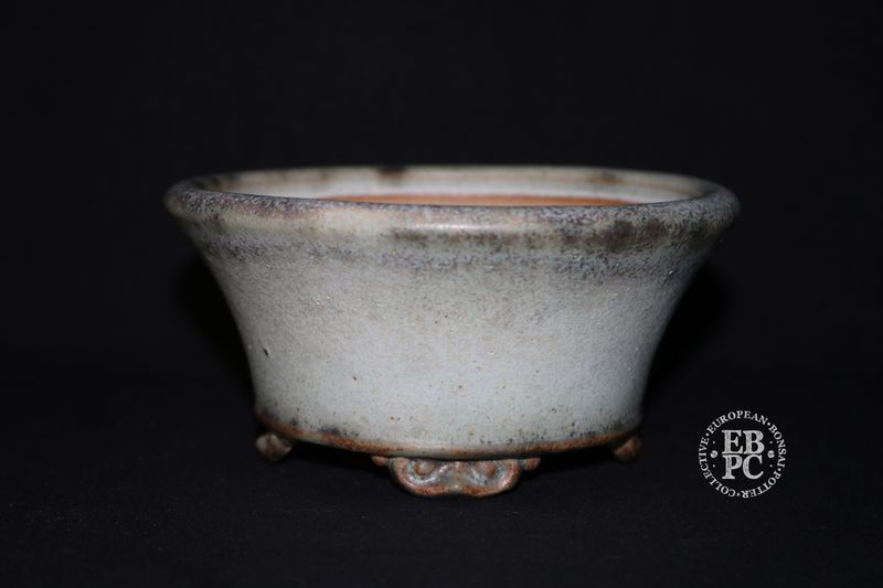 Ian Baillie - 13.2cm; Round; Flared Design; Superb Glaze; Antique White; Scroll Feet; Basal Band.        Made by Ian Baillie of Scotland.