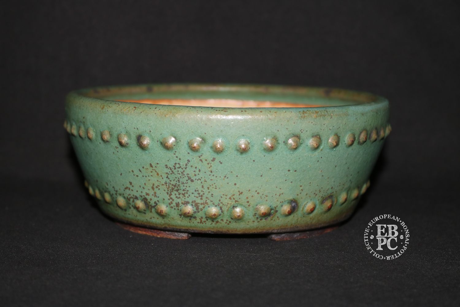Ian Baillie - 17.3cm; Round; Deep Drum Style; Superb Glaze; Rivets/Studs; Pastel Greens; Browns.      Made by Ian Baillie of Scotland.
