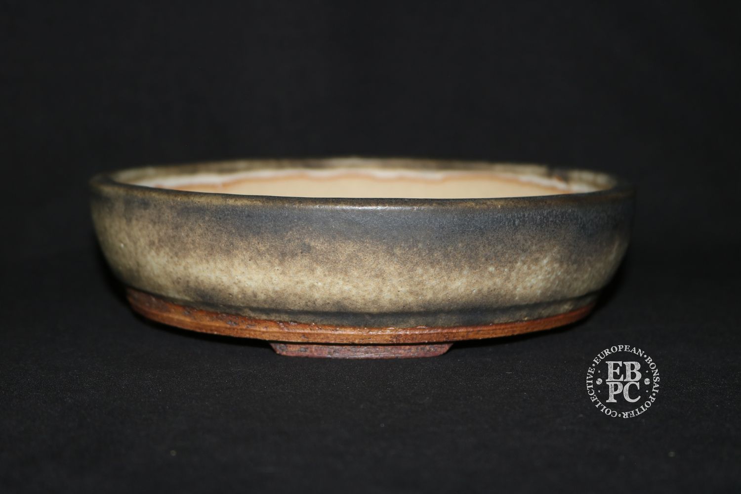 Ian Baillie - 19.5cm; Round; Traditional Design; Superb Glaze; Antique Burnt Cream; Recessed Feet; Incised Basal Band.        Made by Ian Baillie of Scotland.