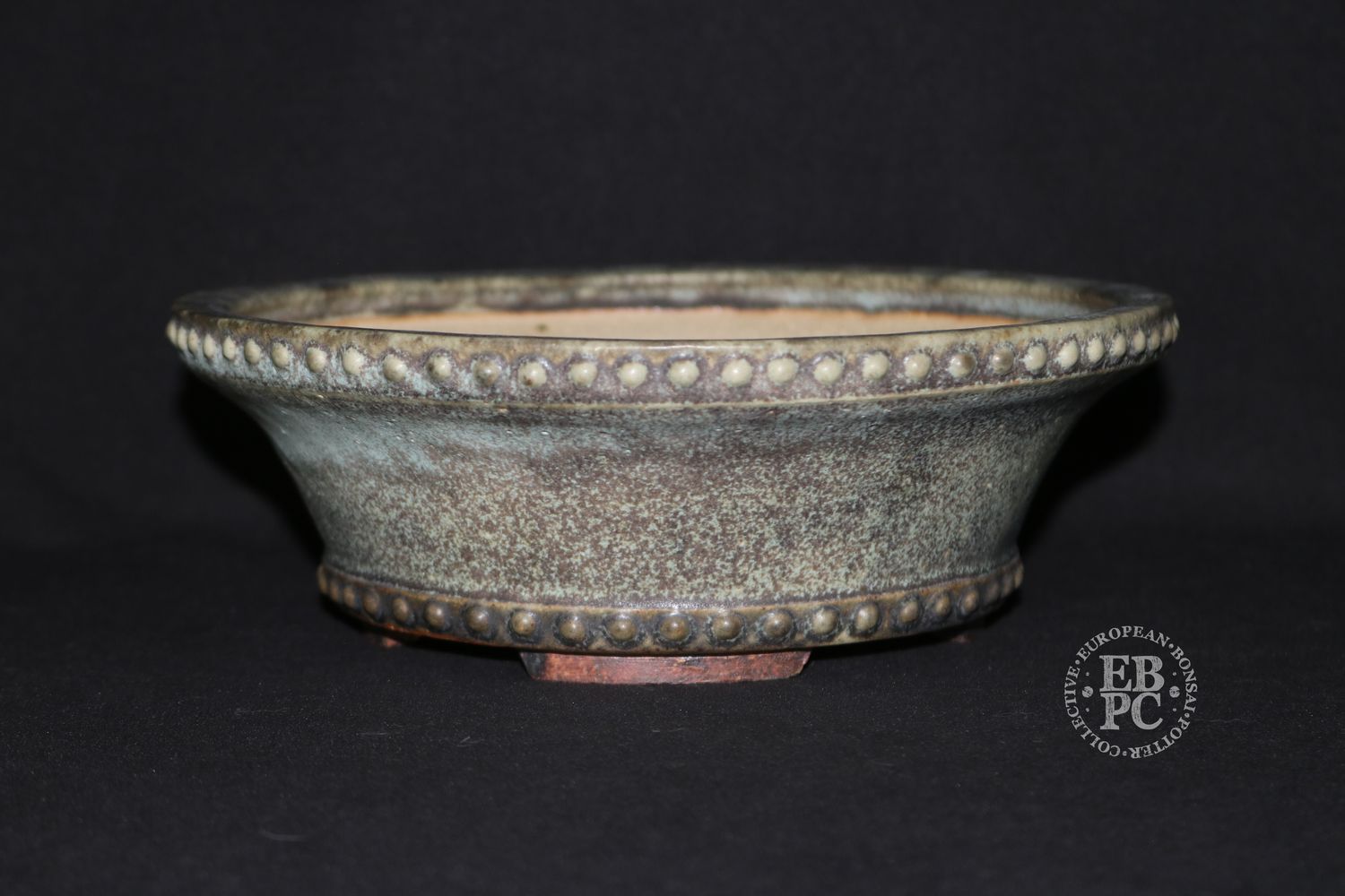 Ian Baillie - 22cm; Round; Deep Drum Style; Superb Glaze; Rivets/Studs; Superb Glaze; Cream; Browns.      Made by Ian Baillie of Scotland.