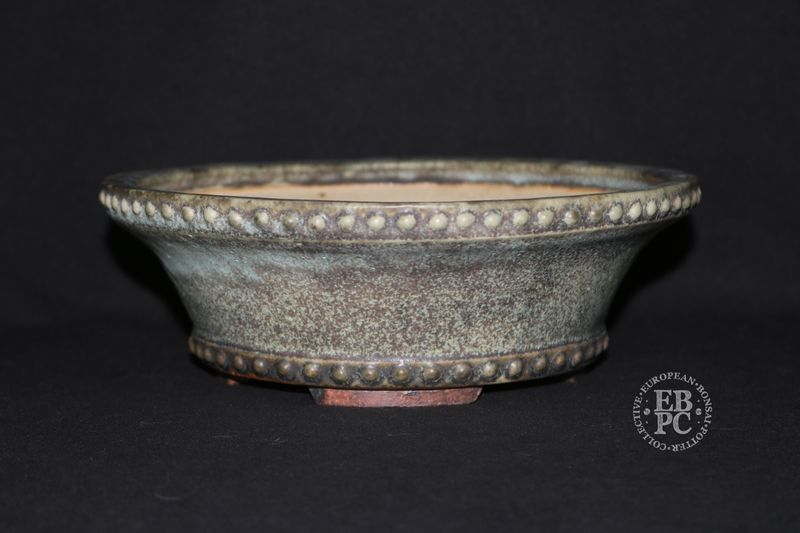 Ian Baillie - 22cm; Round; Deep Drum Style; Superb Glaze; Rivets/Studs; Superb Glaze; Cream; Browns.      Made by Ian Baillie of Scotland.