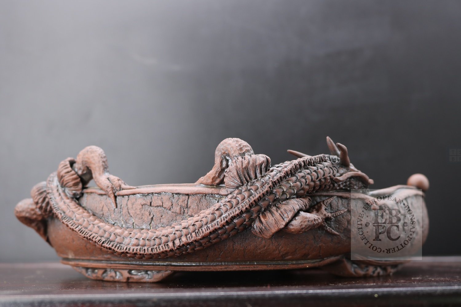 M.B. Berenbrinker - SOLD 26cm; European; kifu; oval; unglazed; brown; dragon; carved