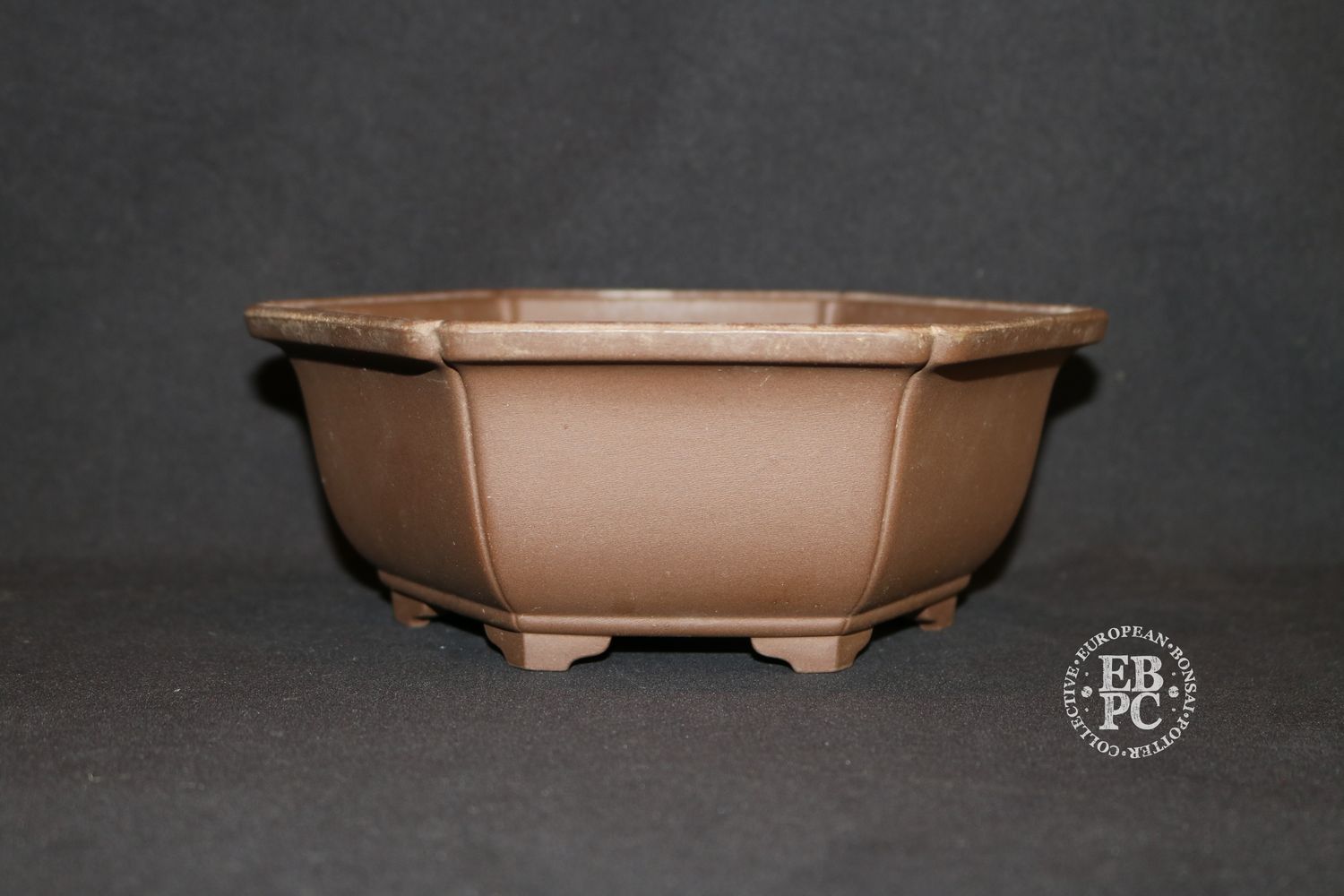 Sankyou, Tokoname, Japan.     18.8cm; Unglazed; Hexagon; Semi-Cascade; Incised Corners;  Stamped.