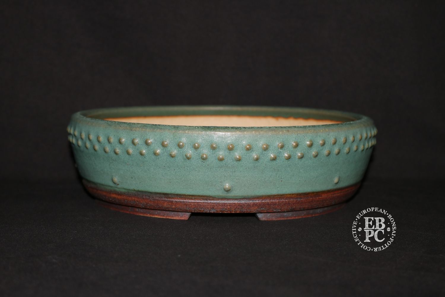Ian Baillie - 26cm; Round; Drum Style; Superb Glaze; Rivets/Studs; Pastel Greens; Subtle Blues.      Made by Ian Baillie of Scotland.