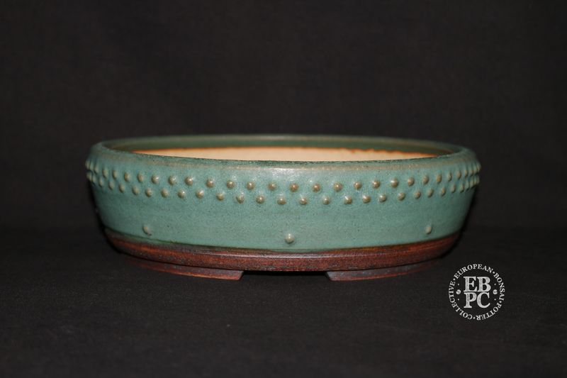 Ian Baillie - 26cm; Round; Drum Style; Superb Glaze; Rivets/Studs; Pastel Greens; Subtle Blues.      Made by Ian Baillie of Scotland.