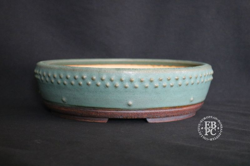 Ian Baillie - 26cm; Round; Drum Style; Superb Glaze; Rivets/Studs; Pastel Greens; Subtle Blues.      Made by Ian Baillie of Scotland.