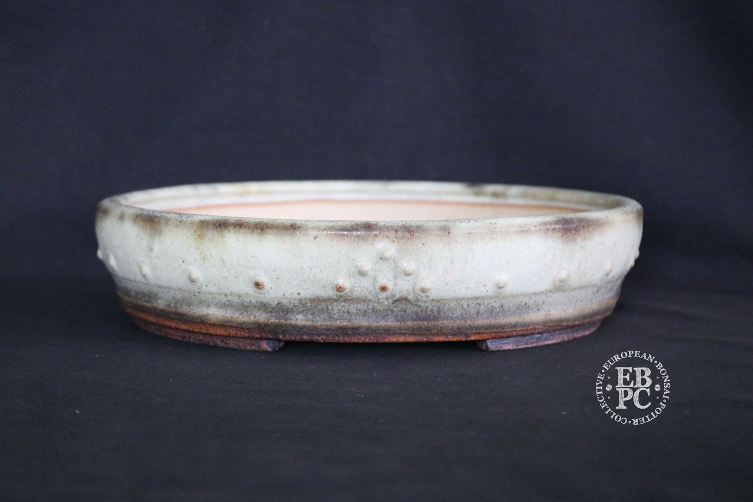 Ian Baillie - 26.7cm; Round; Drum Style; Superb Aged-looking Glaze;  Rivets/Studs; Light Mint Green; Cream; Browns;     Made by Ian Baillie of Scotland.