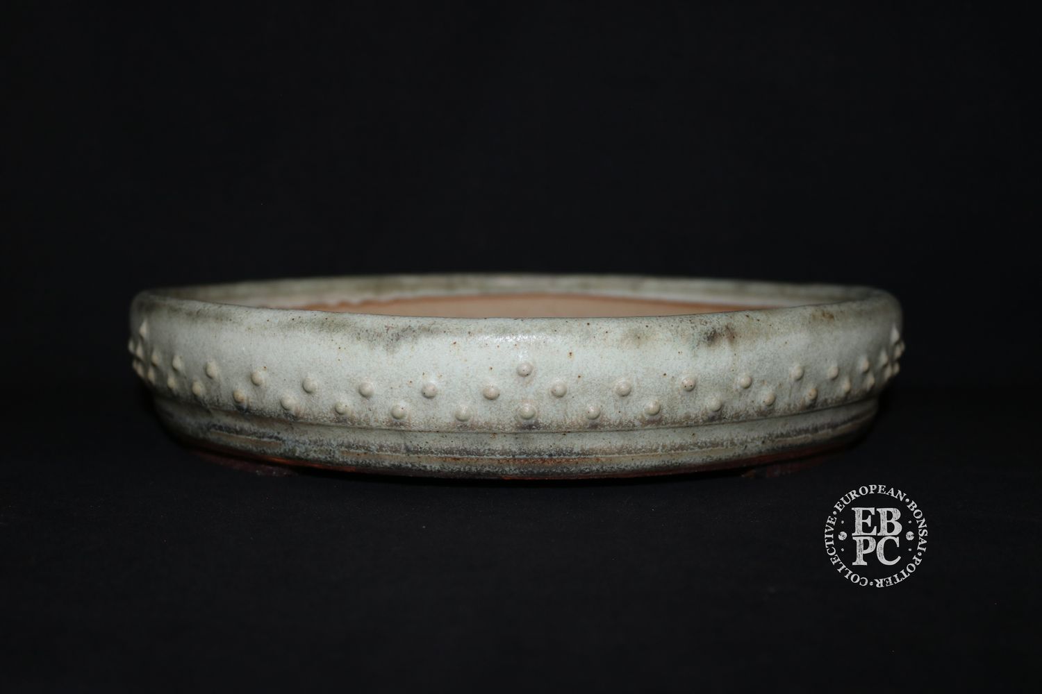 Ian Baillie - 32.1cm; Round; Drum Style; Superb Aged-looking Glaze; Rivets/Studs; Ivory/Bone; Light Mint Green; Browns;      Made by Ian Baillie of Scotland.