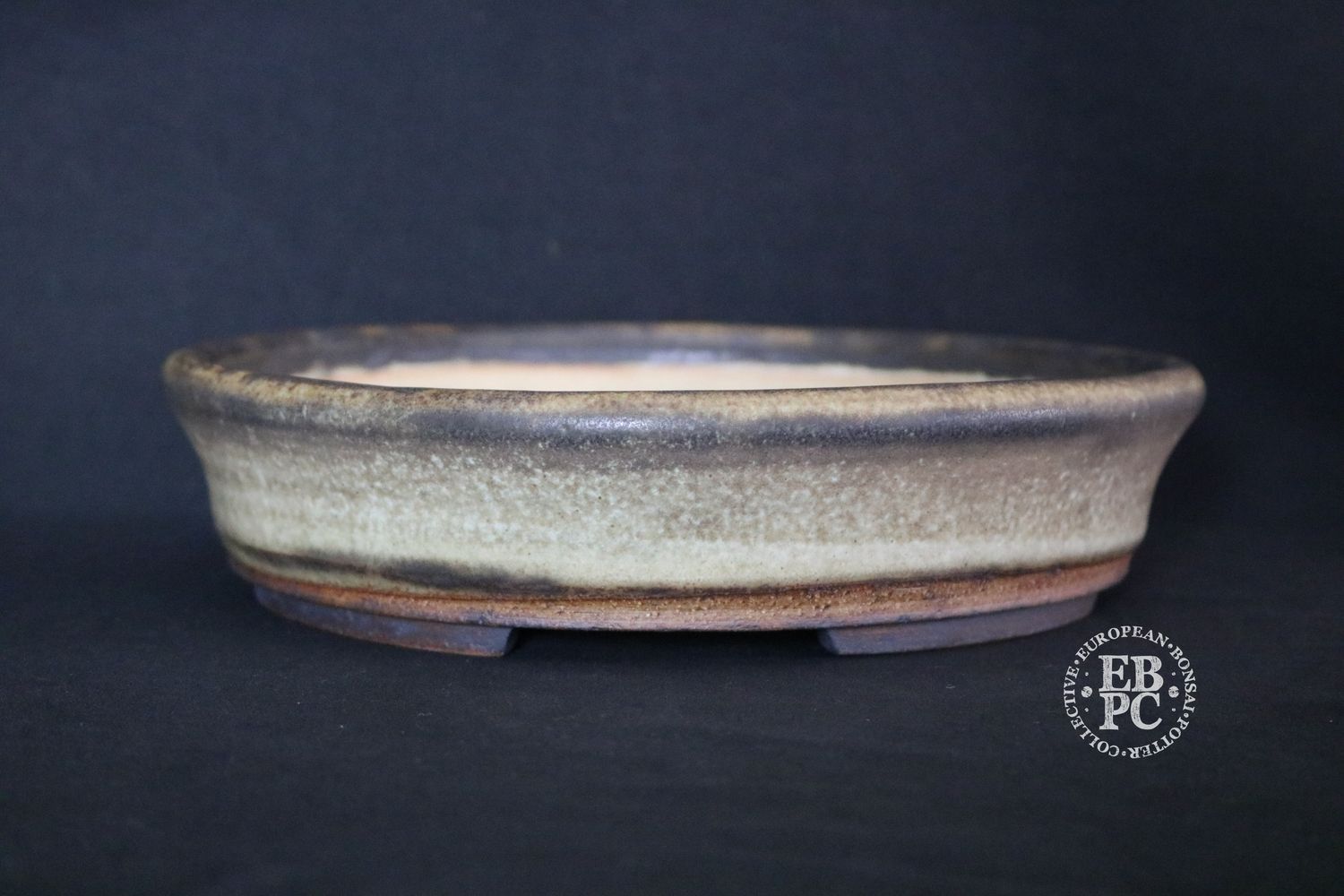 Ian Baillie - 25cm; Round; Low Flared Design Superb Glaze; Cream; Browns; Recessed Feet; Basal Band.        Made by Ian Baillie of Scotland.
