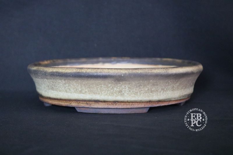 Ian Baillie - 25cm; Round; Low Flared Design Superb Glaze; Cream; Browns; Recessed Feet; Basal Band.        Made by Ian Baillie of Scotland.