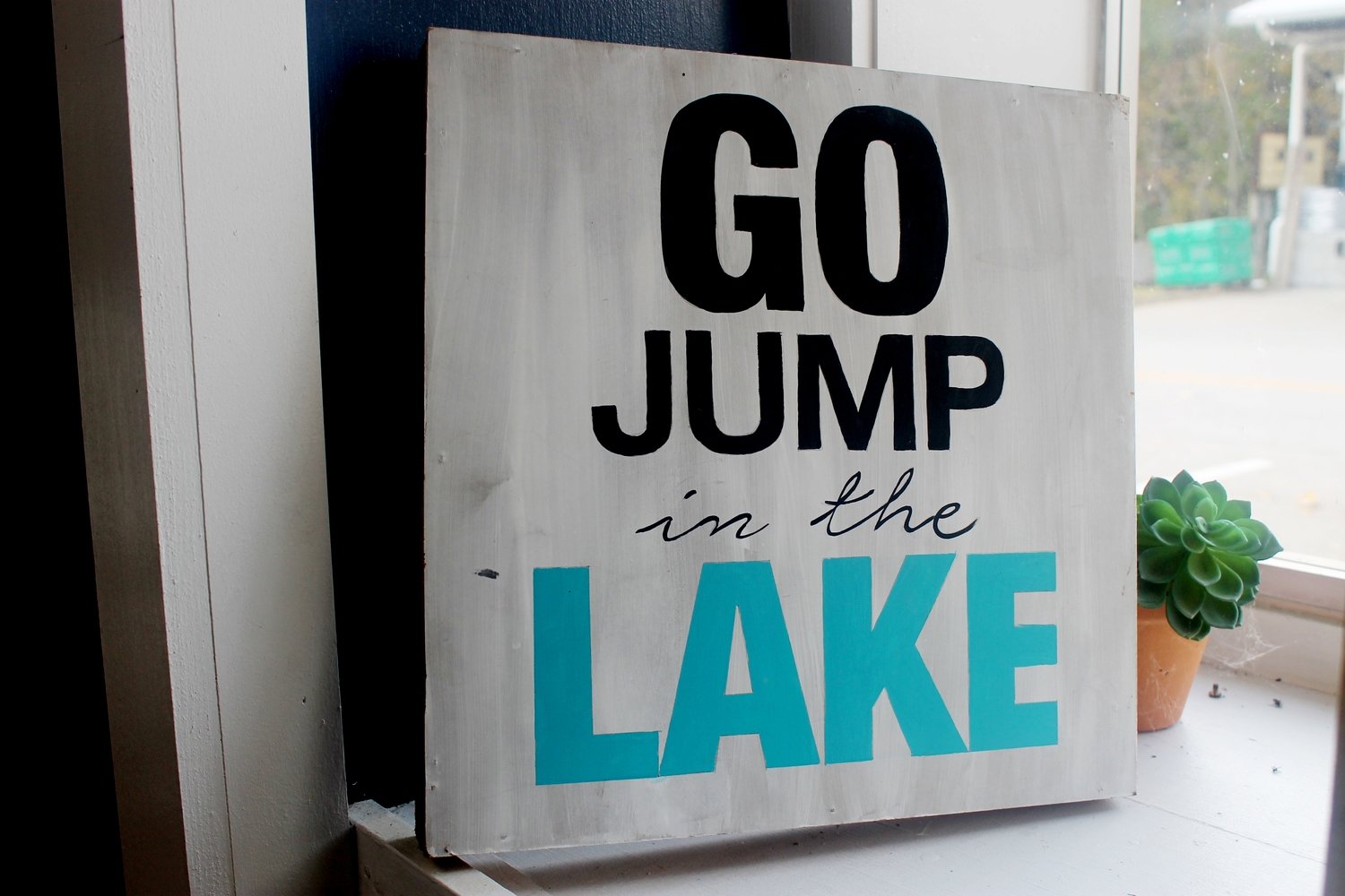 Home Expression Go Jump in the Lake Sign