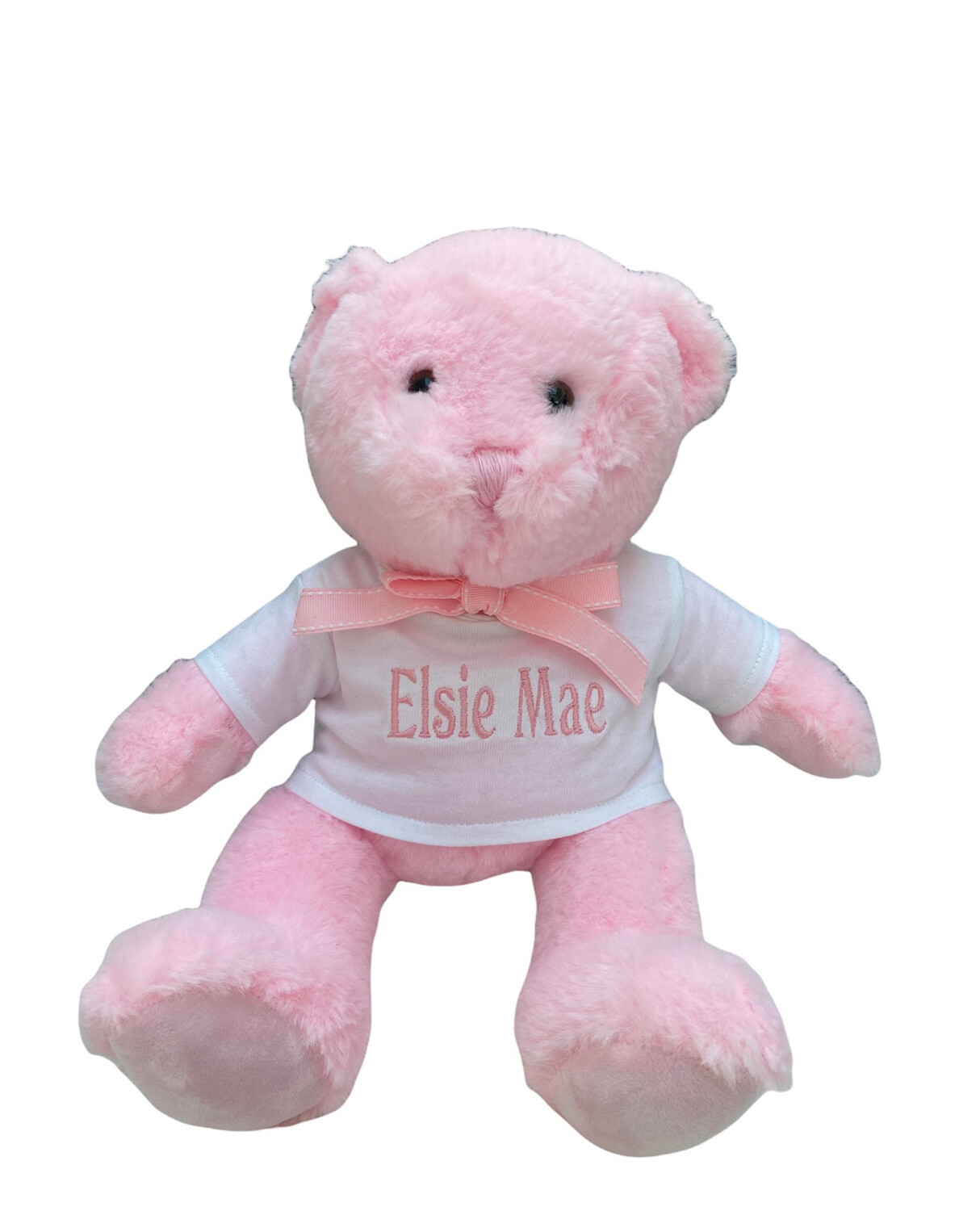 Small pink teddy bear with spot ribbon