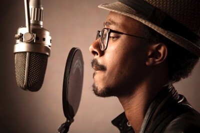 A man in a voice recording studio.