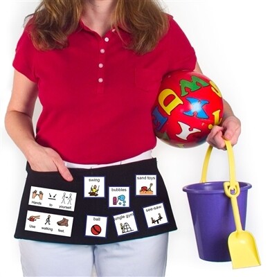 Woman wearing a waist apron pointing to symbols attached.