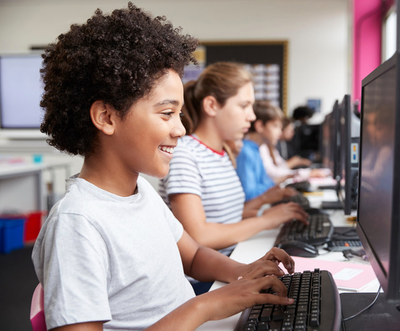 A group of children in a computer lab.