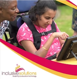 A lady and her friend look at her communication device while she types a message.