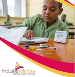 A boy is sitting at his school desk doing some work.