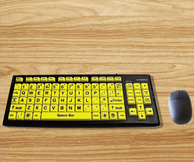 A wooden desktop with a high contrast keyboard and a mouse.