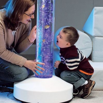 A teacher and a child with Downs Syndrome enjoy a Rompa Bubble Tube.