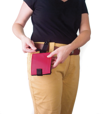 An adult with a communication book attached to their belt