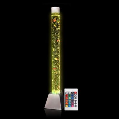 A tall bubble tube lit in yellow, with a small remote
