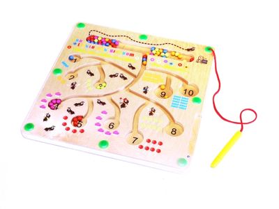 Wooden surface with paths carved into it. A magnetic pen is attached to the game with a red string