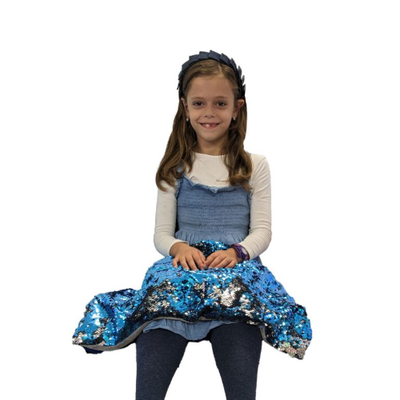 Image of a girl with a sequin weighted lap pad draped over her lap