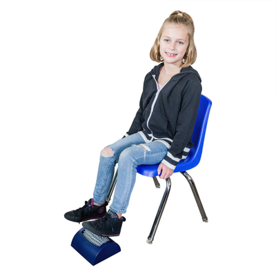 Image of a girl sitting on a chair, with her feet on the foot roller