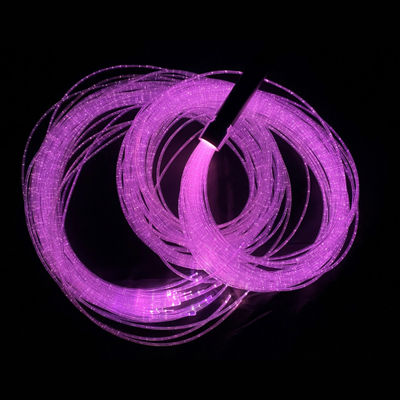 Image of a handheld fibre optic wand with tails, lit in purple