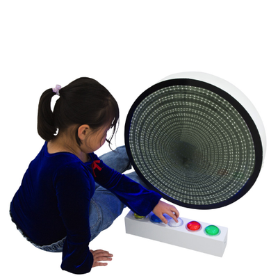 Image of girl pressing giant remote buttons to change colour on infinity mirror