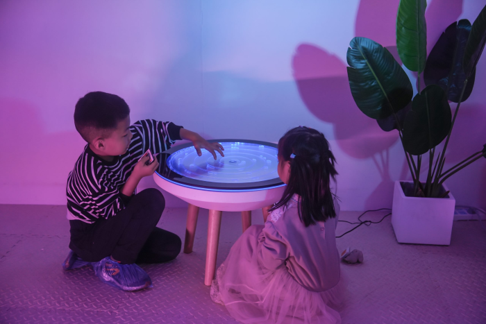 Image showing two children sitting next to maze bubble table