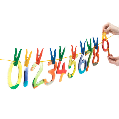 Multi-coloured squidgy sparkle numbers set pegged onto a line
