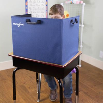 Image of child sitting at a desk behind the portable concentration/privacy partition