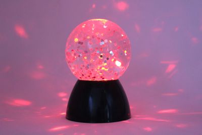Image of sensory glitter waterball lamp lit in red