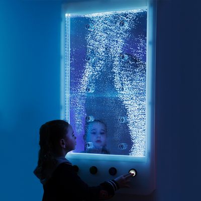 Image of a child pressing a button on the interactive wall hanging bubble wall