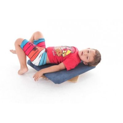 Image showing a boy lying supine on a  rotating sensory skateboard